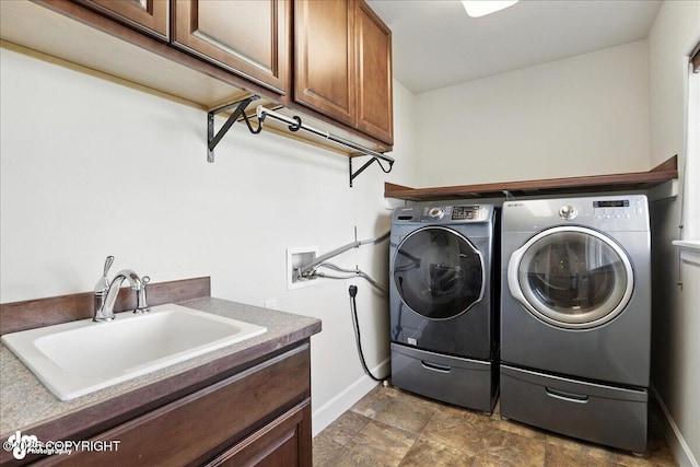 1677 Circlewood Dr, Anchorage, AK 99516 - laundry area with independent washer and dryer, cabinet space, and stone finish floors