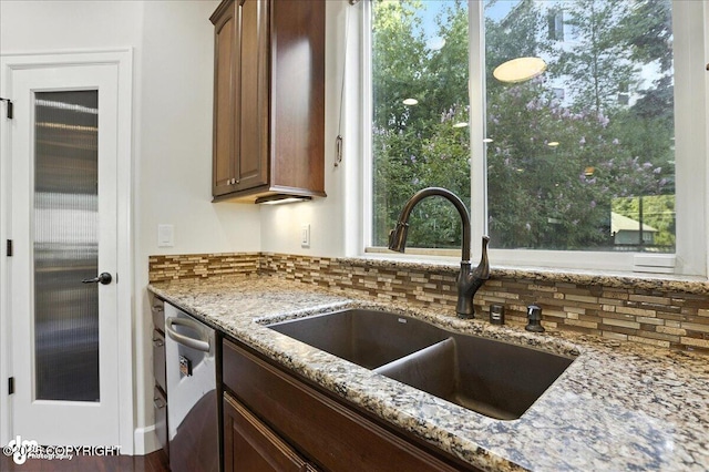 1677 Circlewood Dr, Anchorage, AK 99516 - kitchen with decorative backsplash, dishwasher, light stone counters, and plenty of natural light