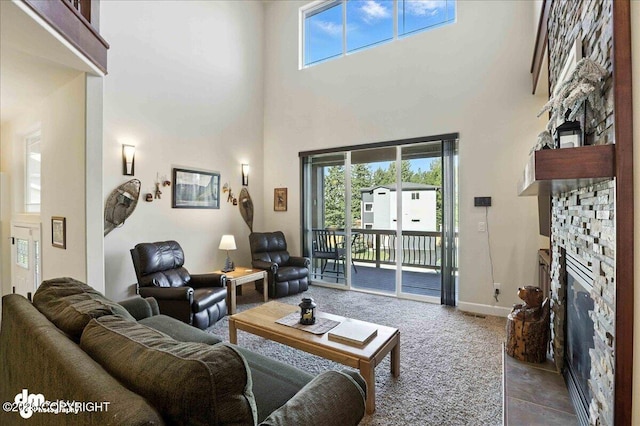 1677 Circlewood Dr, Anchorage, AK 99516 - carpeted living room featuring a stone fireplace and a towering ceiling
