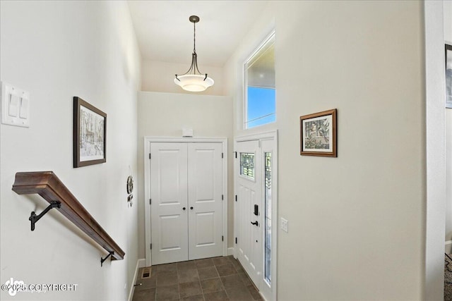 1677 Circlewood Dr, Anchorage, AK 99516 - entryway featuring baseboards and a high ceiling