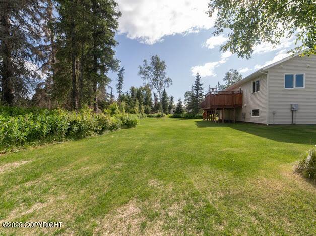 1207 Portside Dr, Kenai, AK 99611 - view of green lawn with a wooden deck