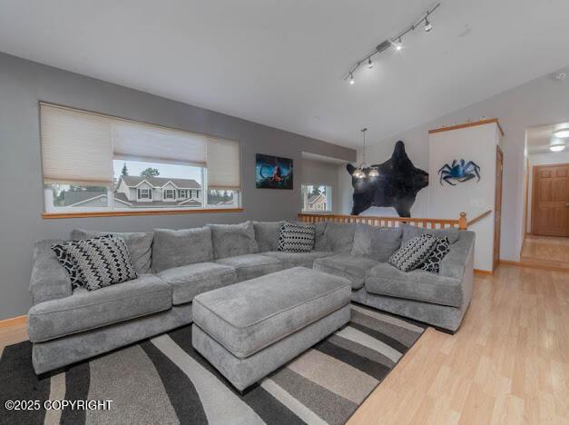 1207 Portside Dr, Kenai, AK 99611 - living room with rail lighting and light wood-type flooring