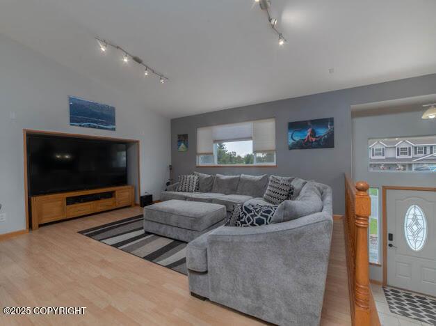 1207 Portside Dr, Kenai, AK 99611 - living room featuring track lighting, wood finished floors, and lofted ceiling