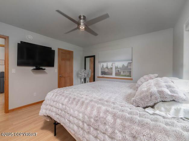 1207 Portside Dr, Kenai, AK 99611 - bedroom with light wood-style flooring and ceiling fan