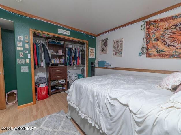 1207 Portside Dr, Kenai, AK 99611 - bedroom featuring ornamental molding, wood finished floors, and a closet