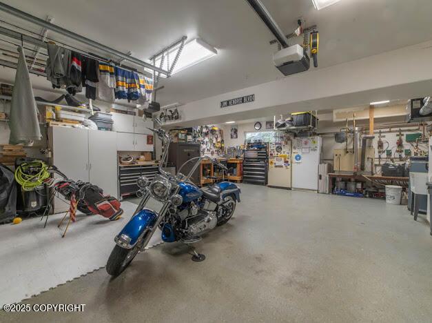 1207 Portside Dr, Kenai, AK 99611 - garage with a garage door opener and a workshop area