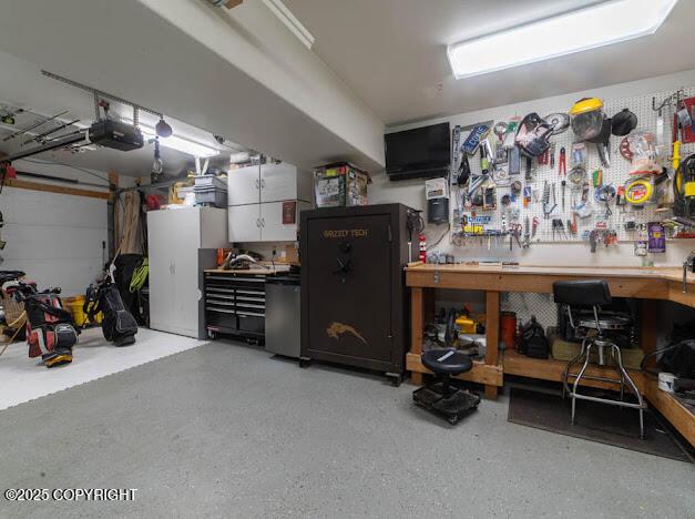 1207 Portside Dr, Kenai, AK 99611 - garage with a workshop area and a garage door opener
