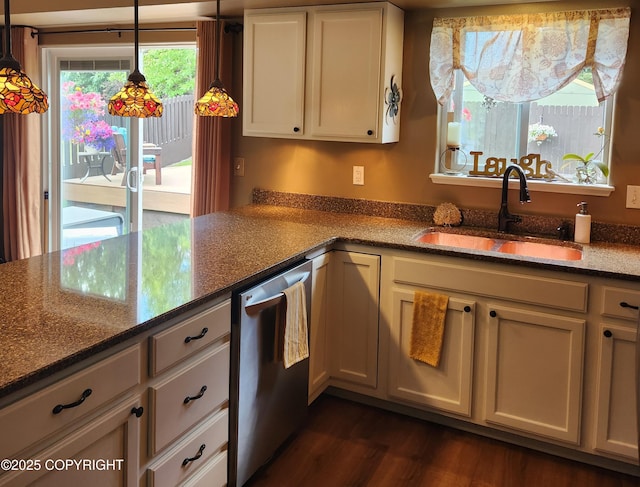 3920 Red Talon Dr, Anchorage, AK 99507 - kitchen with dishwasher, dark stone counters, dark wood-type flooring, and decorative light fixtures