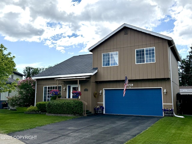 3920 Red Talon Dr, Anchorage, AK 99507 - view of front of house with a front yard, asphalt driveway, and an attached garage