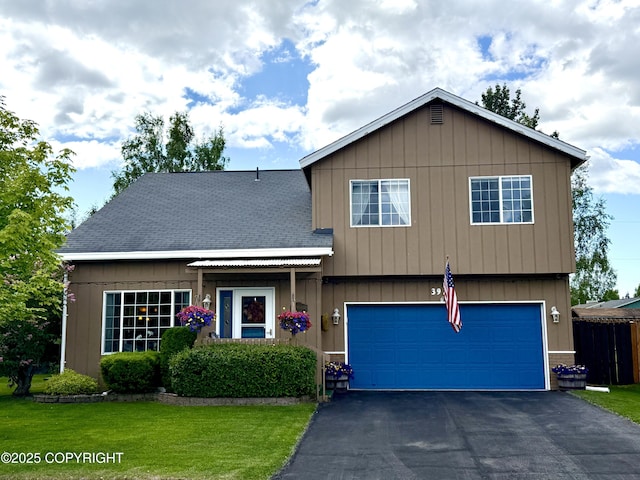 3920 Red Talon Dr, Anchorage, AK 99507 - view of front of home with asphalt driveway, a front yard, an attached garage, and board and batten siding