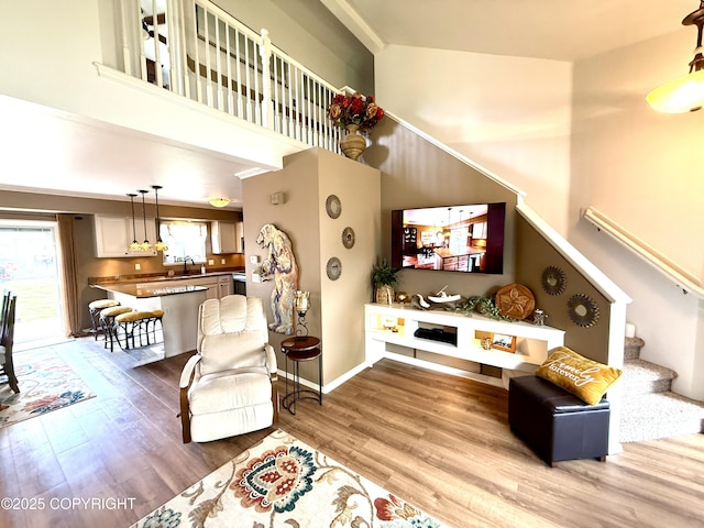 3920 Red Talon Dr, Anchorage, AK 99507 - living area featuring light wood-type flooring, a high ceiling, and stairway