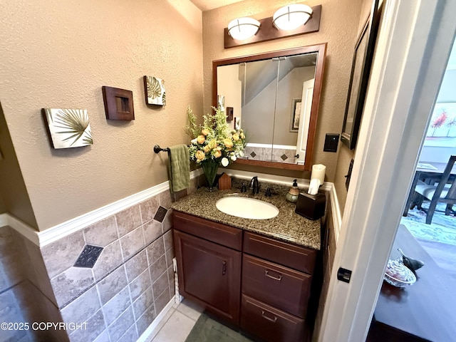 3920 Red Talon Dr, Anchorage, AK 99507 - bathroom featuring vanity, tile walls, and a wainscoted wall