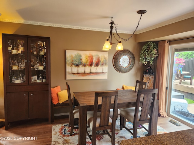 3920 Red Talon Dr, Anchorage, AK 99507 - dining space featuring wood finished floors and crown molding
