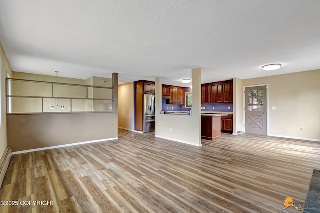 3223 Madison Way, Anchorage, AK 99508 - unfurnished living room with light wood-style floors and a textured ceiling