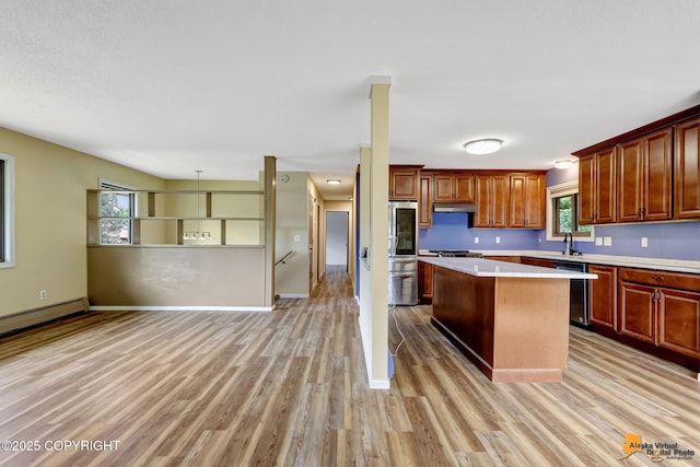 3223 Madison Way, Anchorage, AK 99508 - kitchen featuring light countertops, smart refrigerator, a center island, under cabinet range hood, and light wood-style floors