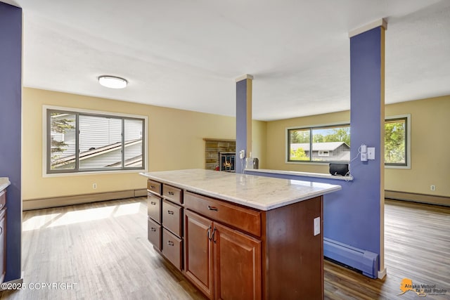 3223 Madison Way, Anchorage, AK 99508 - kitchen with a baseboard heating unit, a baseboard radiator, wood finished floors, and a kitchen island