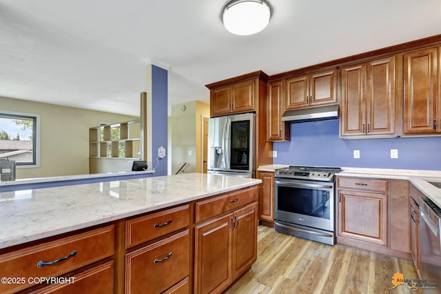 3223 Madison Way, Anchorage, AK 99508 - kitchen with appliances with stainless steel finishes, under cabinet range hood, light wood-style floors, light stone countertops, and brown cabinetry