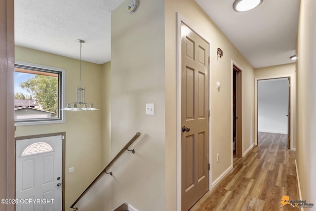 3223 Madison Way, Anchorage, AK 99508 - foyer featuring light wood-type flooring and a textured ceiling