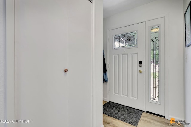 4800 Carousel Cir, Anchorage, AK 99502 - foyer entrance featuring light wood-style flooring and baseboards