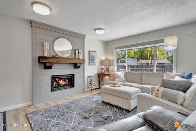 4800 Carousel Cir, Anchorage, AK 99502 - living room featuring wood finished floors, baseboard heating, a large fireplace, and a textured ceiling