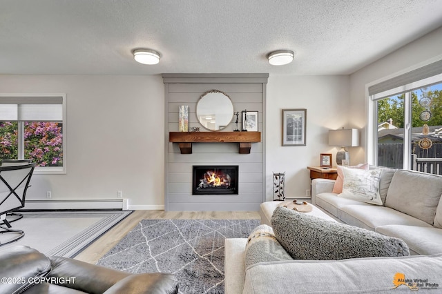 4800 Carousel Cir, Anchorage, AK 99502 - living room with baseboard heating, wood finished floors, a large fireplace, and a textured ceiling