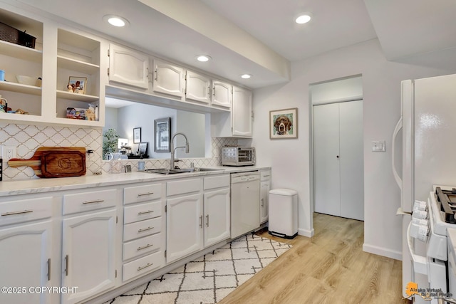 4800 Carousel Cir, Anchorage, AK 99502 - kitchen with white dishwasher, range, light wood finished floors, white cabinets, and tasteful backsplash