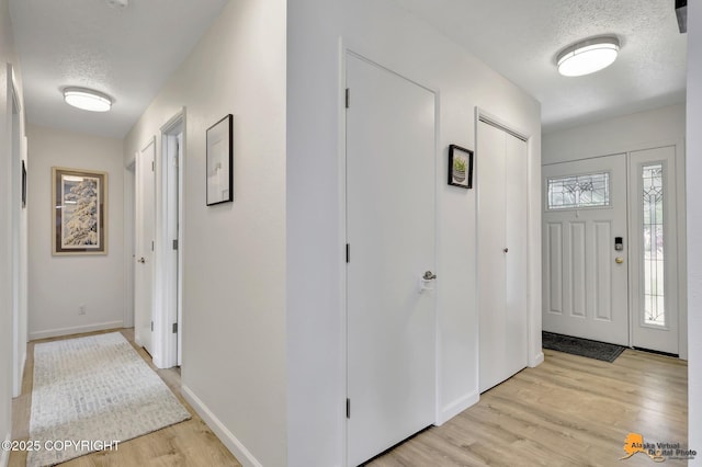 4800 Carousel Cir, Anchorage, AK 99502 - foyer entrance featuring a textured ceiling and light wood finished floors