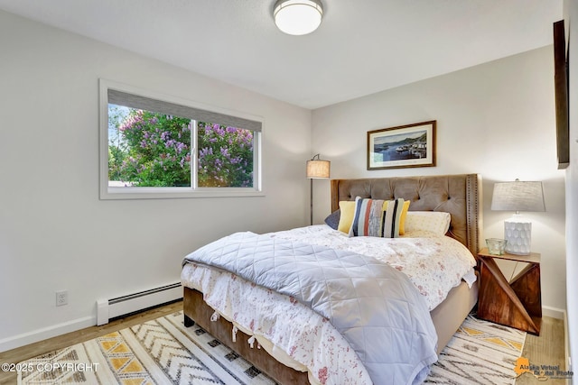 4800 Carousel Cir, Anchorage, AK 99502 - bedroom featuring a baseboard heating unit and wood finished floors