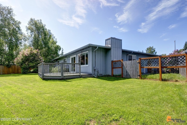 4800 Carousel Cir, Anchorage, AK 99502 - rear view of house featuring board and batten siding, a deck, and a chimney
