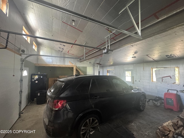 21577 Evelyn May St, Kasilof, AK 99610 - garage featuring concrete block wall and a garage door opener