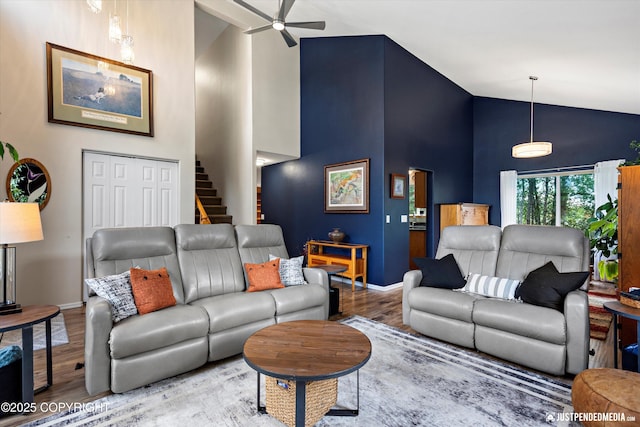 2943 Kingfisher Dr, Anchorage, AK 99502 - living area featuring high vaulted ceiling, wood finished floors, a ceiling fan, and stairway