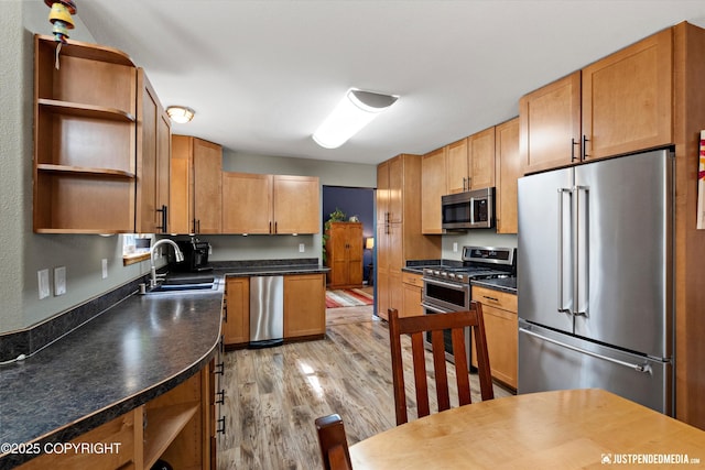 2943 Kingfisher Dr, Anchorage, AK 99502 - kitchen with appliances with stainless steel finishes, open shelves, light wood-style floors, and dark countertops