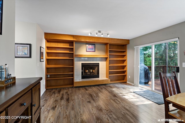 2943 Kingfisher Dr, Anchorage, AK 99502 - living room with dark wood-type flooring, a tile fireplace, and built in shelves