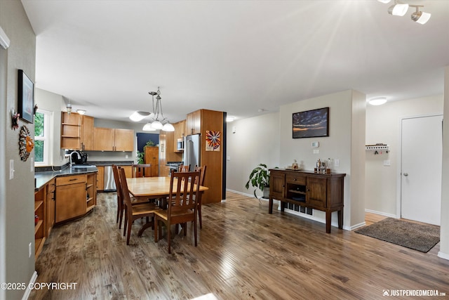 2943 Kingfisher Dr, Anchorage, AK 99502 - dining space featuring dark wood-style flooring and a chandelier
