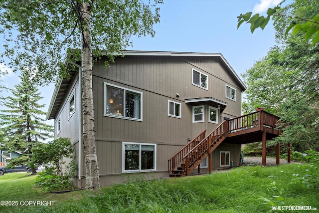 2943 Kingfisher Dr, Anchorage, AK 99502 - rear view of house with stairway, a deck, and a yard