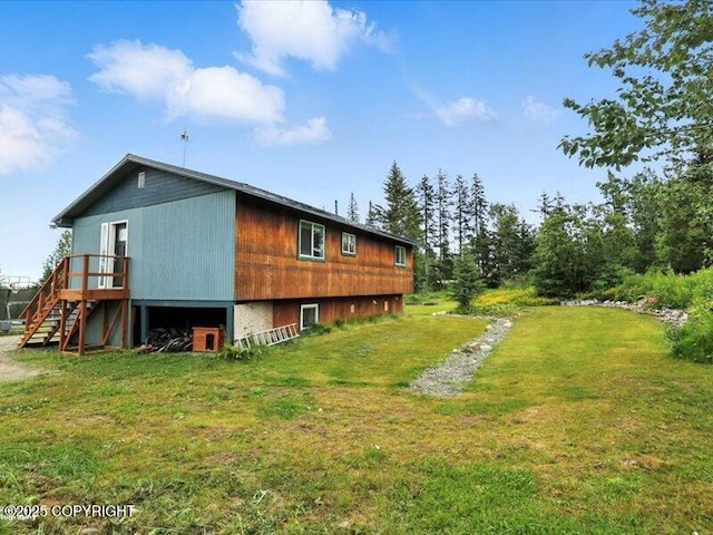 72155 Shannon Rd, Anchor Point, AK 99556 - view of side of home with stairs, a lawn, and a wooden deck
