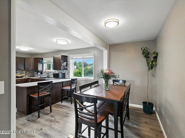 72155 Shannon Rd, Anchor Point, AK 99556 - dining room featuring light wood-type flooring and a textured ceiling
