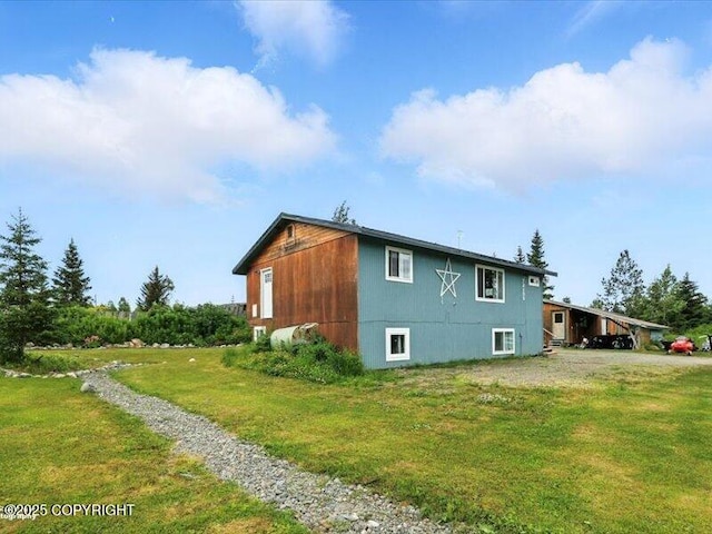 72155 Shannon Rd, Anchor Point, AK 99556 - view of home's exterior featuring a lawn and a carport
