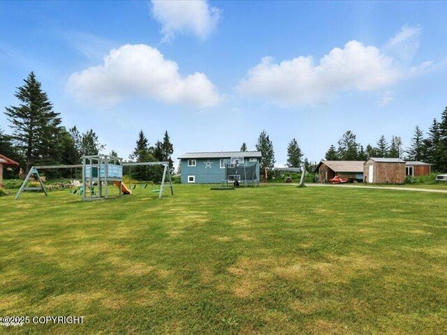 72155 Shannon Rd, Anchor Point, AK 99556 - view of green lawn featuring a playground and a trampoline