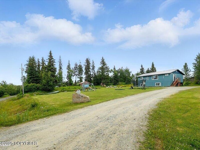 72155 Shannon Rd, Anchor Point, AK 99556 - view of front of home with a playground, driveway, and a front lawn