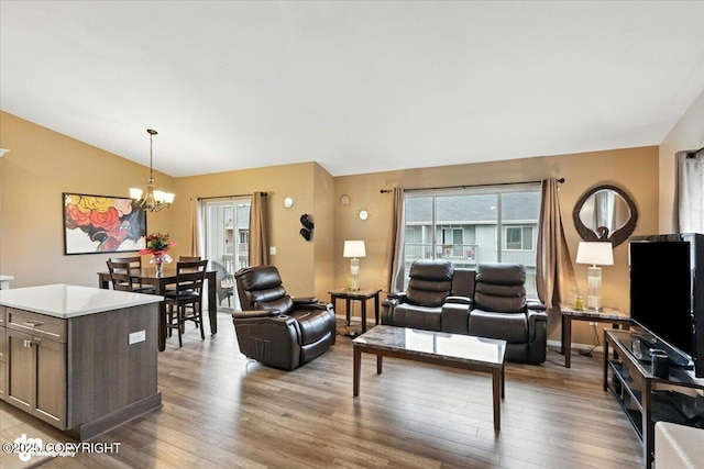 2608 Lauren Creek Loop # 4, Anchorage, AK 99507 - living area featuring lofted ceiling, a chandelier, healthy amount of natural light, and wood finished floors