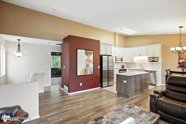 2608 Lauren Creek Loop # 4, Anchorage, AK 99507 - kitchen featuring appliances with stainless steel finishes, open floor plan, light countertops, and light wood-style flooring