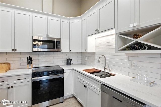 2608 Lauren Creek Loop # 4, Anchorage, AK 99507 - kitchen with stainless steel appliances and white cabinetry