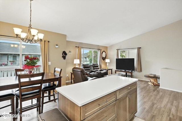 2608 Lauren Creek Loop # 4, Anchorage, AK 99507 - kitchen featuring a chandelier, light wood-style flooring, vaulted ceiling, hanging light fixtures, and light countertops
