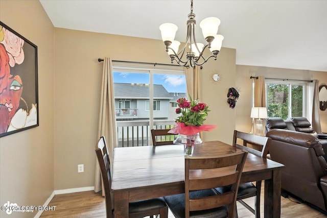 2608 Lauren Creek Loop # 4, Anchorage, AK 99507 - dining room featuring a chandelier and light wood-type flooring
