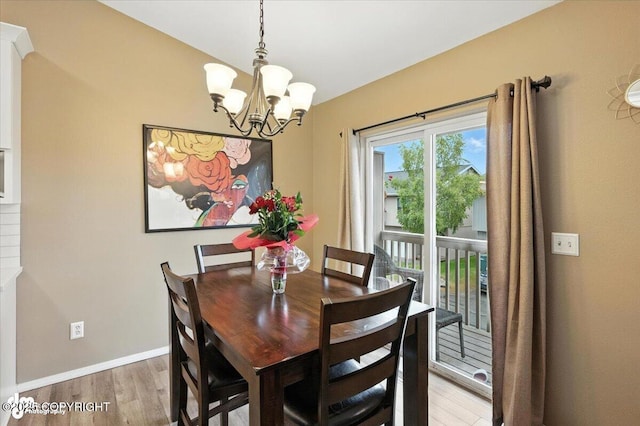 2608 Lauren Creek Loop # 4, Anchorage, AK 99507 - dining room with a chandelier and light wood-type flooring