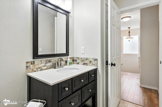 2608 Lauren Creek Loop # 4, Anchorage, AK 99507 - bathroom with vanity, backsplash, and wood finished floors