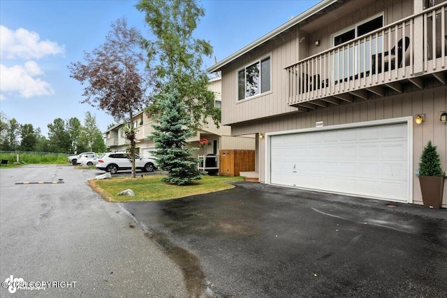 2608 Lauren Creek Loop # 4, Anchorage, AK 99507 - view of front of property featuring a balcony, an attached garage, and driveway