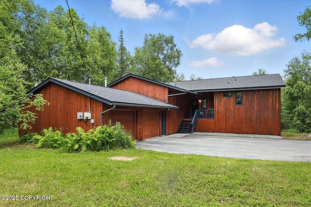 3291 N Edgewater Dr, Wasilla, AK 99623 - view of front of home with an attached garage, driveway, and a front lawn