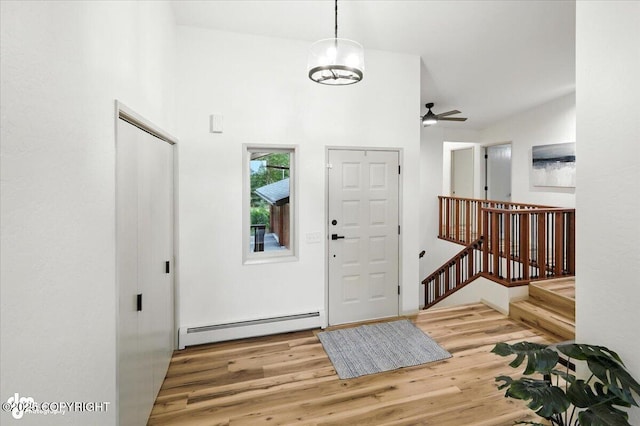 3291 N Edgewater Dr, Wasilla, AK 99623 - foyer featuring a baseboard heating unit, wood finished floors, and a ceiling fan